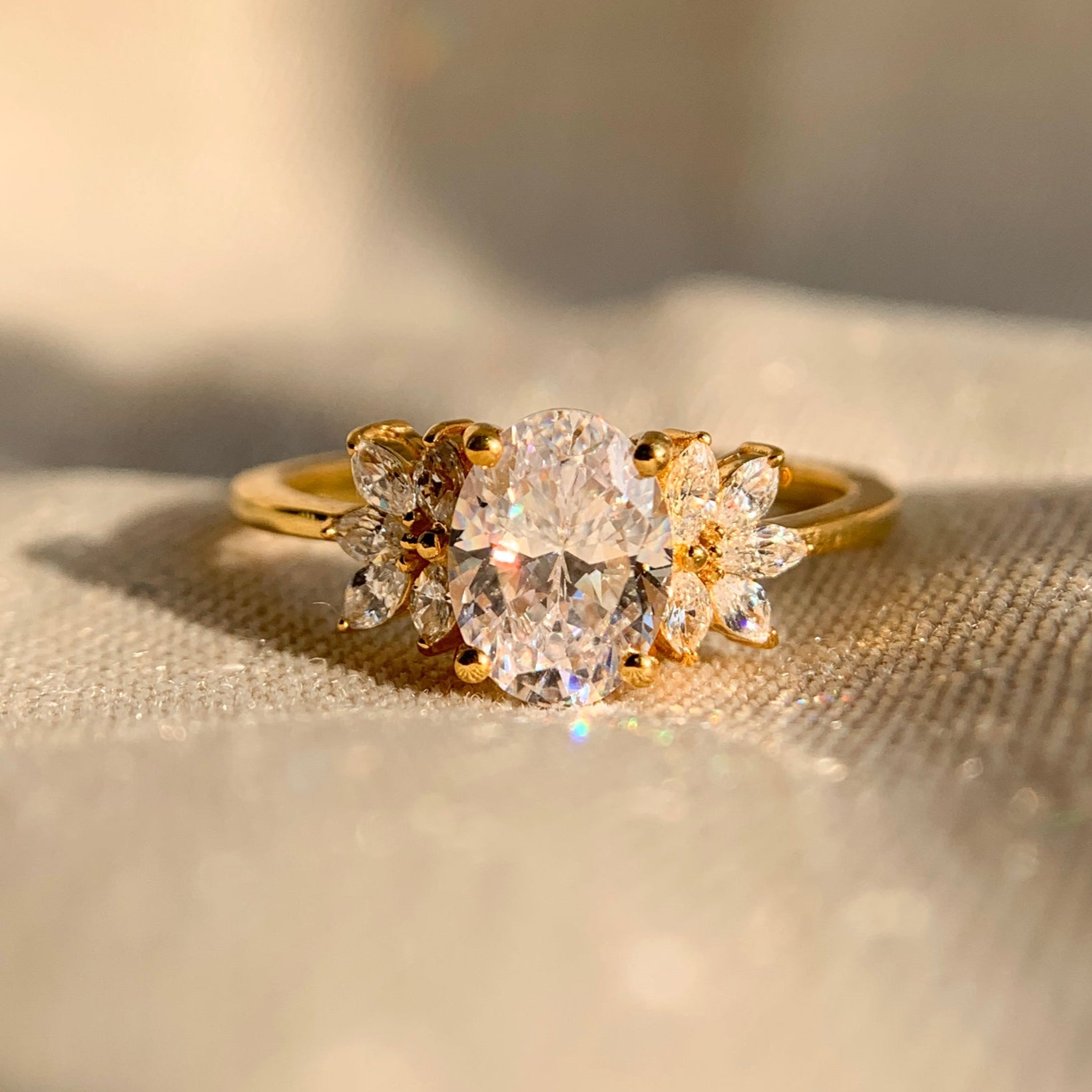 “1.25 carat oval engagement ring with marquise side stones in elegant solitaire design”